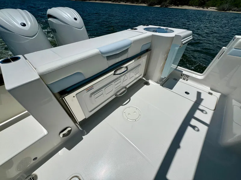 Slide: The Image of 2025 Robalo R257 Dual Console boat interior with seating and storage, on a sunny day. - 19