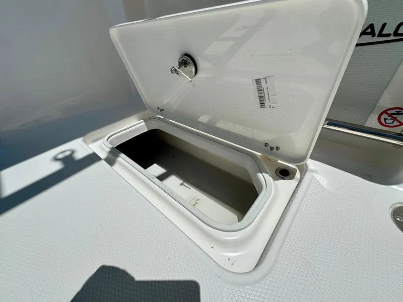 Slide: The Image of Open storage compartment on 2025 Robalo R257 Dual Console boat. - 28