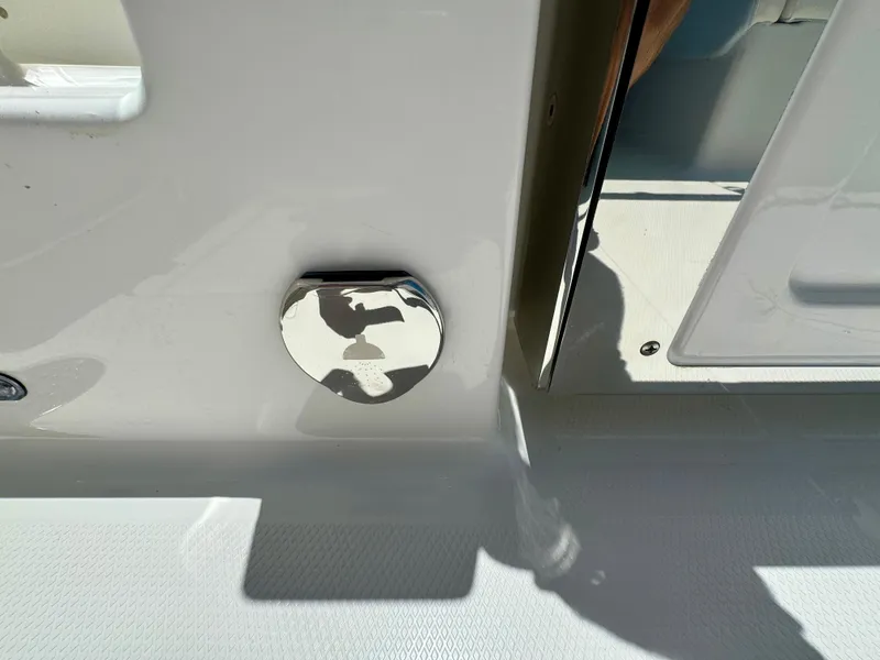 Slide: The Image of 2025 Robalo R257 Dual Console boat detail with chrome fixture and shadow. - 31