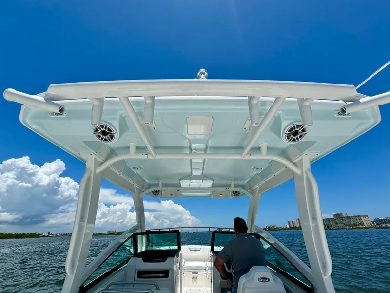 Slide: The Image of 2025 Robalo R257 Dual Console boat on water under clear blue sky. - 32