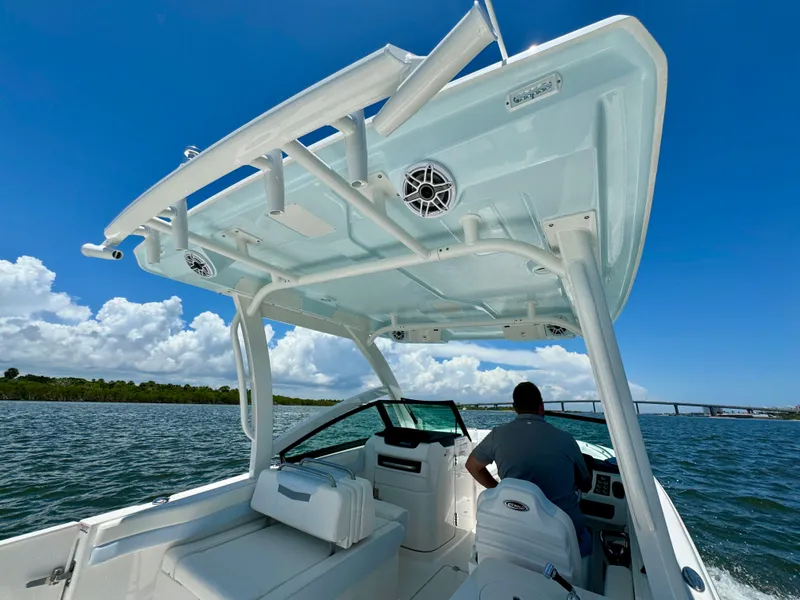 Slide: The Image of 2025 Robalo R257 Dual Console boat cruising on a sunny day, featuring a sleek design. - 34