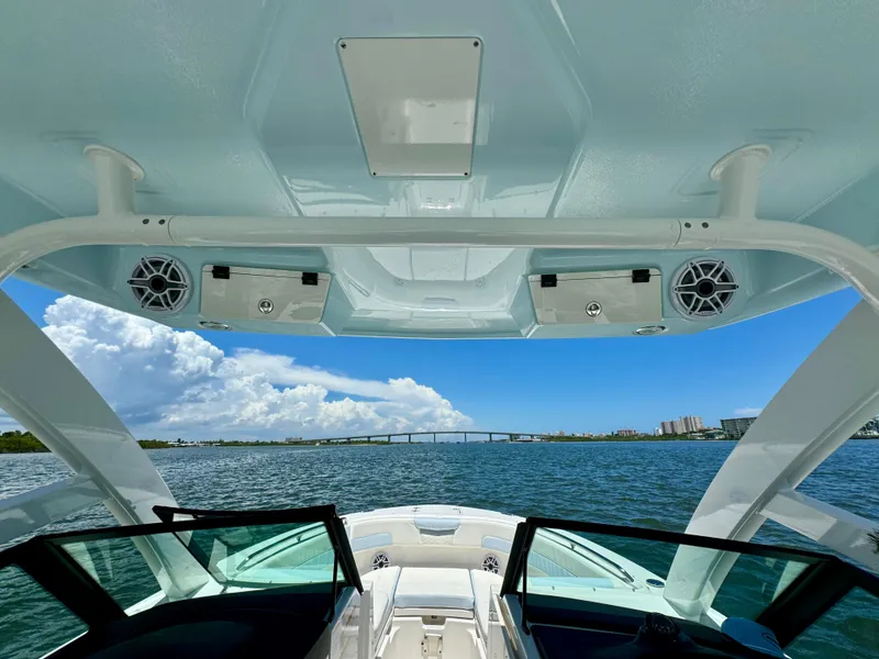 Slide: The Image of 2025 Robalo R257 Dual Console boat interior with ocean view and bridge in background. - 35