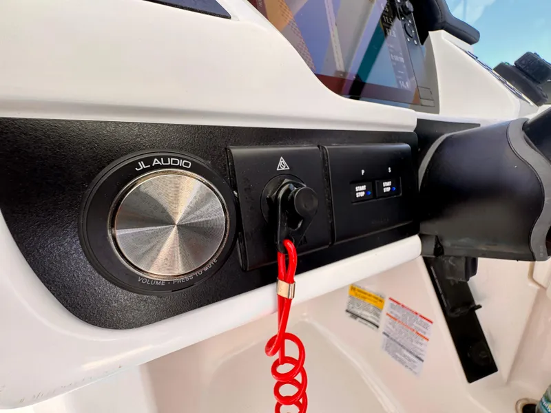 Slide: The Image of 2025 Robalo R257 Dual Console dashboard with JL Audio system and controls. - 37
