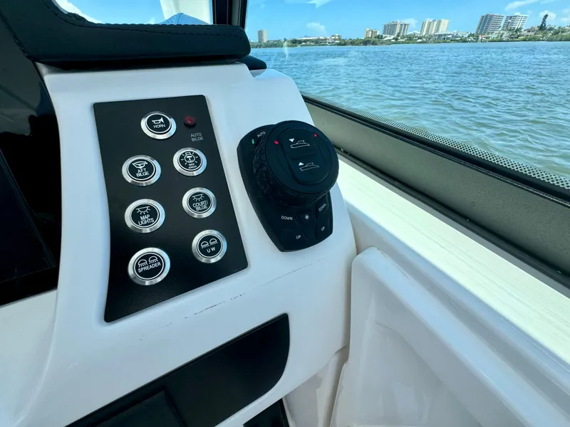 Slide: The Image of Control panel of 2025 Robalo R257 Dual Console boat with water view. - 38
