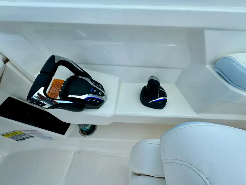 Slide: The Image of 2025 Robalo R257 Dual Console boat controls with modern design and ergonomic seating. - 39