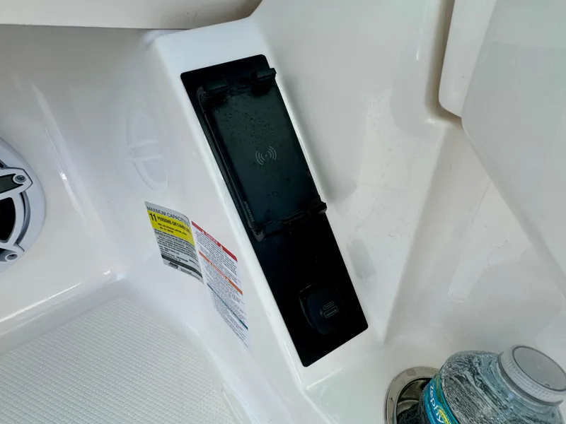 Slide: The Image of 2025 Robalo R257 Dual Console boat interior with wireless charging pad and speaker. - 41