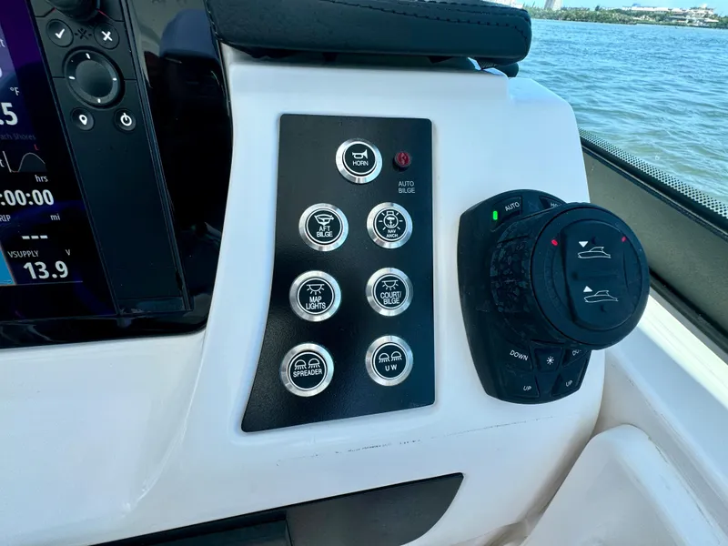 Slide: The Image of Control panel of 2025 Robalo R257 Dual Console boat with various switches and dials. - 43