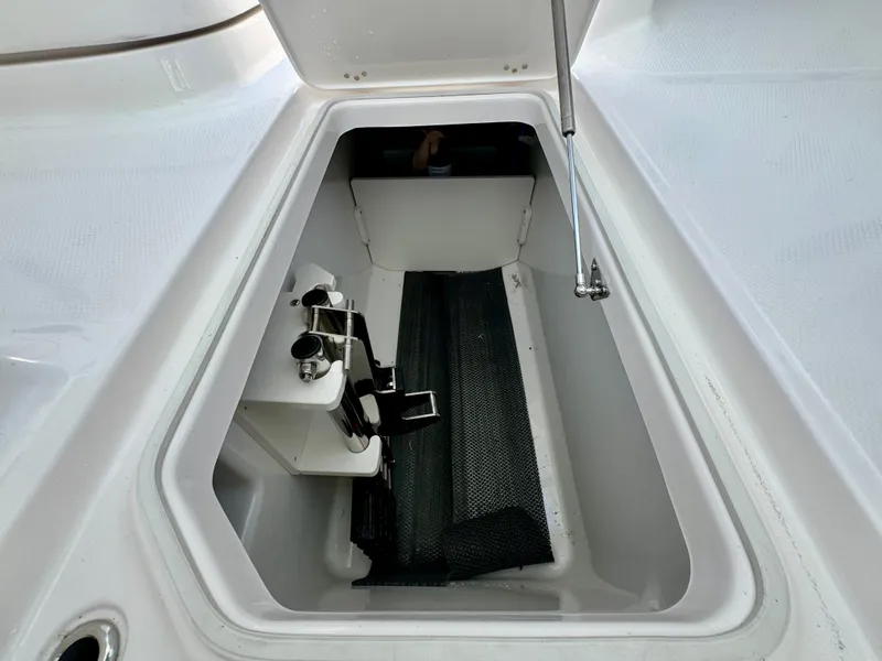 Slide: The Image of Storage compartment of 2025 Robalo R257 Dual Console boat, featuring organized interior space. - 47