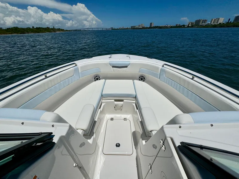 Slide: The Image of 2025 Robalo R257 Dual Console on calm water with clear view. - 49