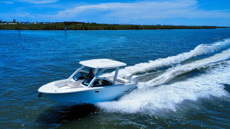 Slide: The Image of 2025 Robalo R257 Dual Console boat cruising on a sunny day in open water. - 9