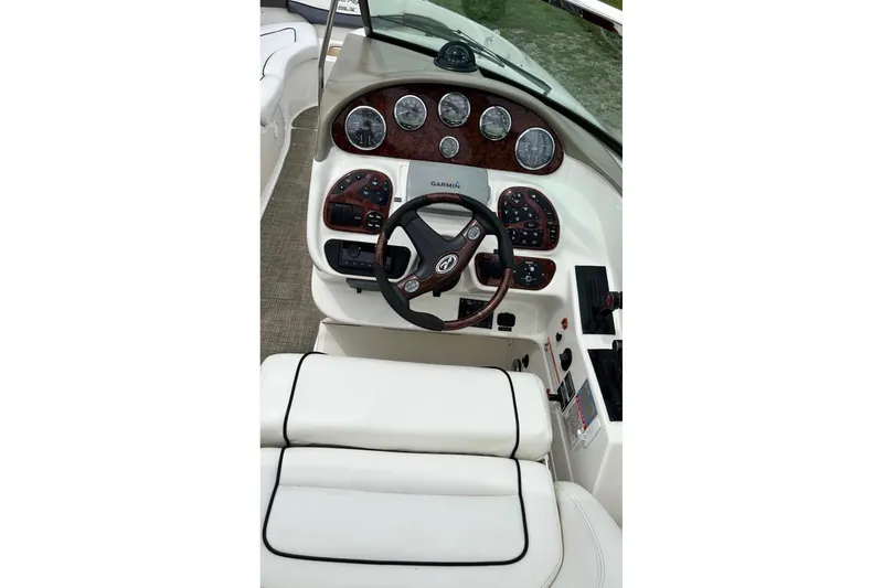 Slide: The Image of 2007 Sea Ray 290 SLX boat dashboard with steering wheel and instrument panel. - 11