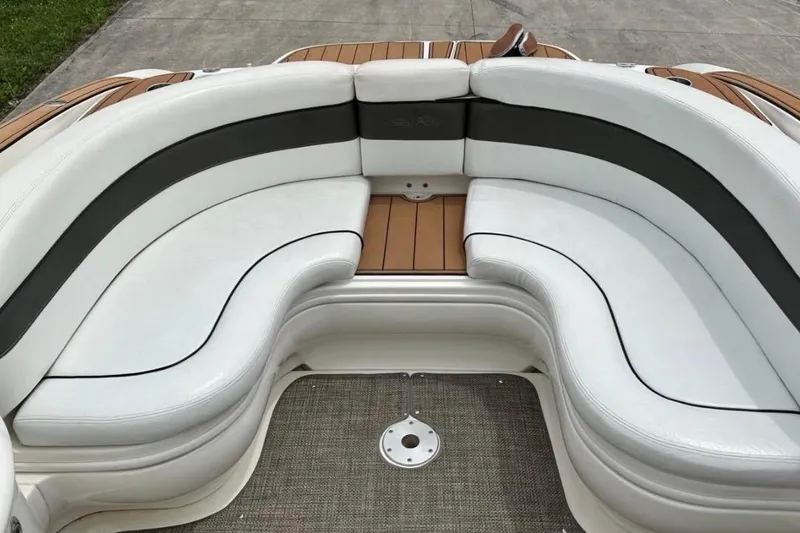 Slide: The Image of 2007 Sea Ray 290 SLX boat interior with white and black cushioned seating. - 13
