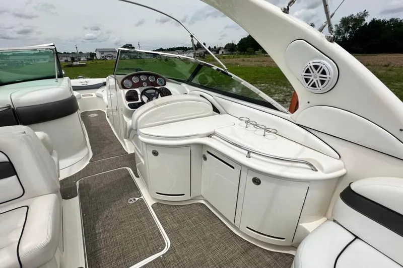 Slide: The Image of 2007 Sea Ray 290 SLX boat interior with sleek white seating and modern dashboard. - 14