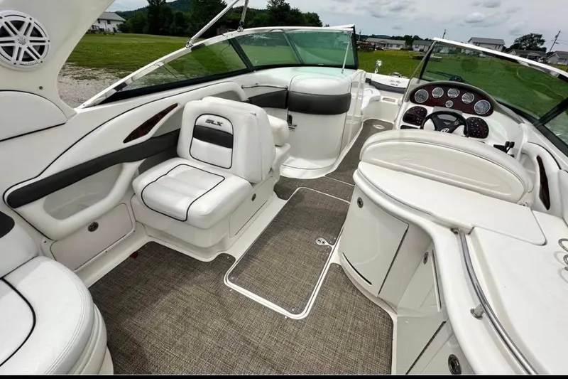 Slide: The Image of 2007 Sea Ray 290 SLX boat interior with white seating and modern dashboard. - 15