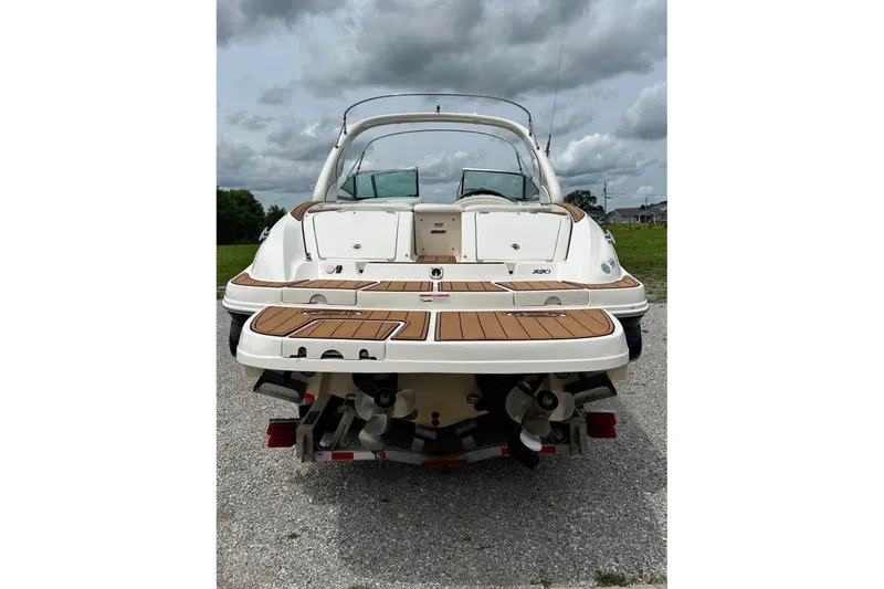 Slide: The Image of 2007 Sea Ray 290 SLX boat, rear view, on a cloudy day. - 4