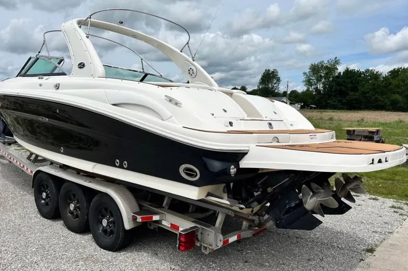 Slide: The Image of 2007 Sea Ray 290 SLX boat on trailer, parked outdoors under cloudy sky. - 5
