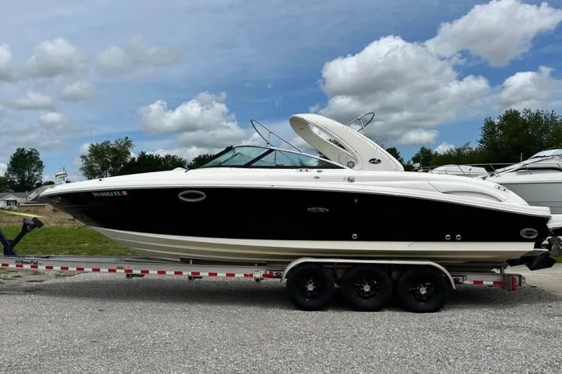 Slide: The Image of 2007 Sea Ray 290 SLX boat on trailer under cloudy sky. - 6