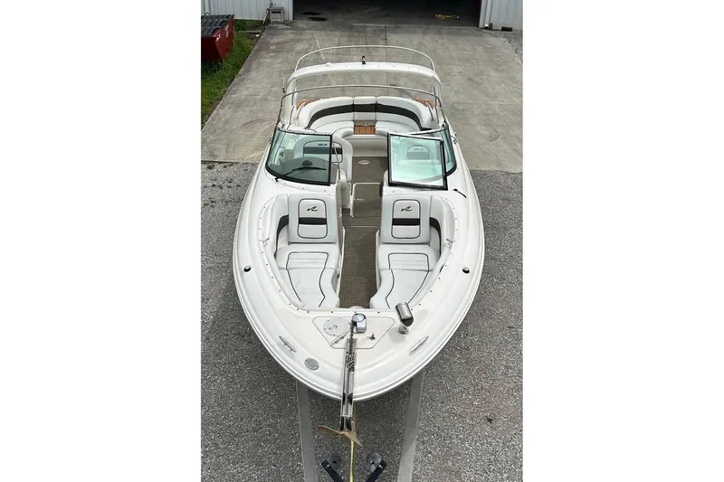 Slide: The Image of 2007 Sea Ray 290 SLX boat, white exterior, docked on concrete surface. - 9