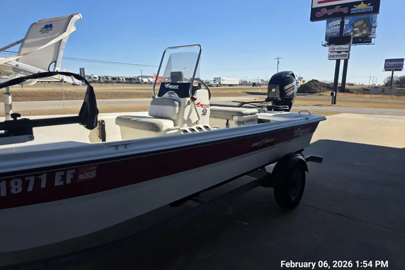 Slide: The Image of 2018 Mako Pro Skiff 17 CC boat on trailer, parked outdoors. - 11