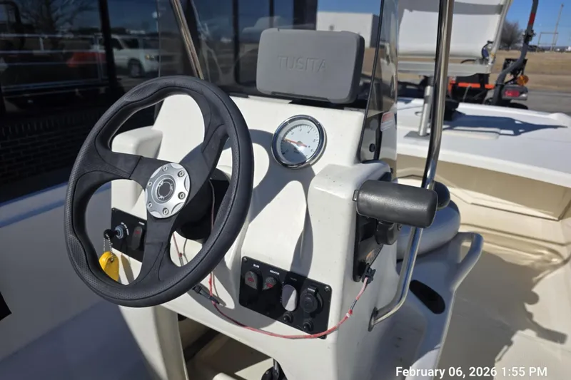 Slide: The Image of 2018 Mako Pro Skiff 17 CC boat console with steering wheel and controls. - 12