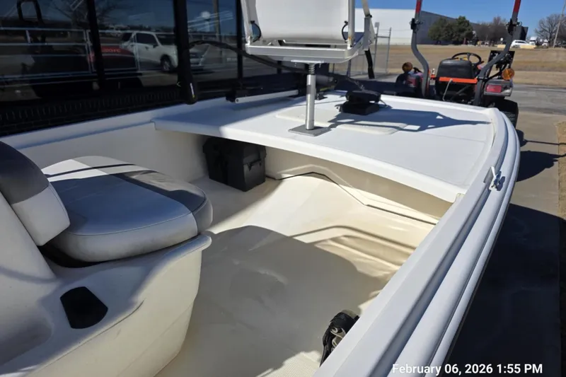 Slide: The Image of 2018 Mako Pro Skiff 17 CC interior with seating and storage, photographed outdoors. - 5