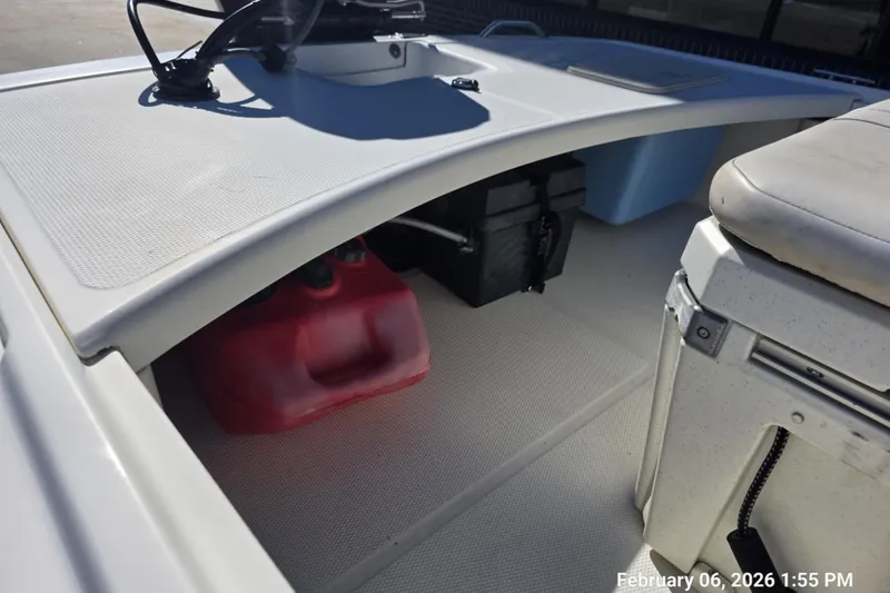 Slide: The Image of 2018 Mako Pro Skiff 17 CC interior with storage compartments and seating. - 6