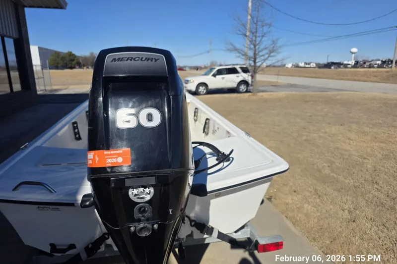 Slide: The Image of 2018 Mako Pro Skiff 17 CC with Mercury 60 engine on trailer, outdoor setting. - 8