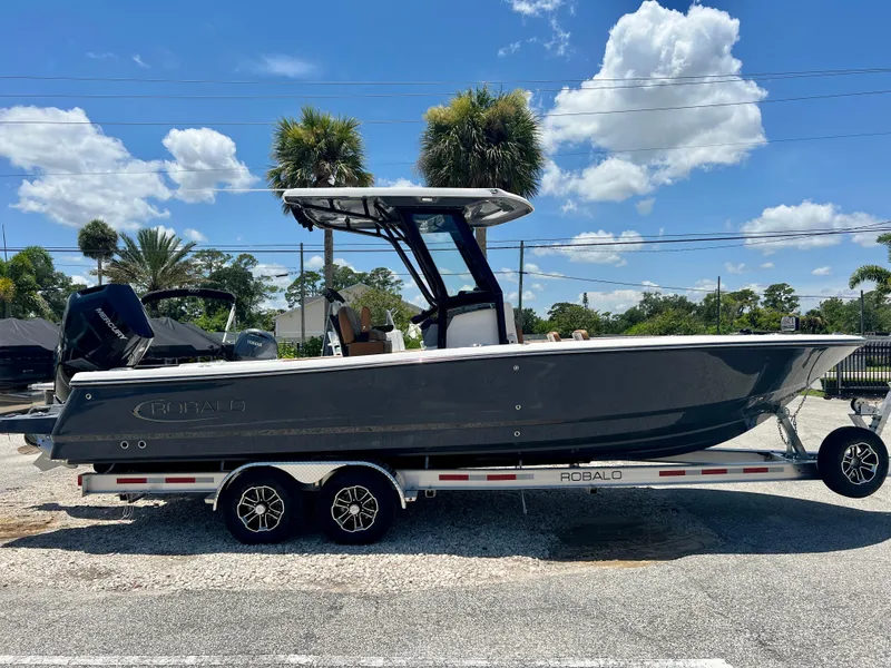 The Image of 2025 Robalo 266 Cayman boat on trailer, sunny day. - 0