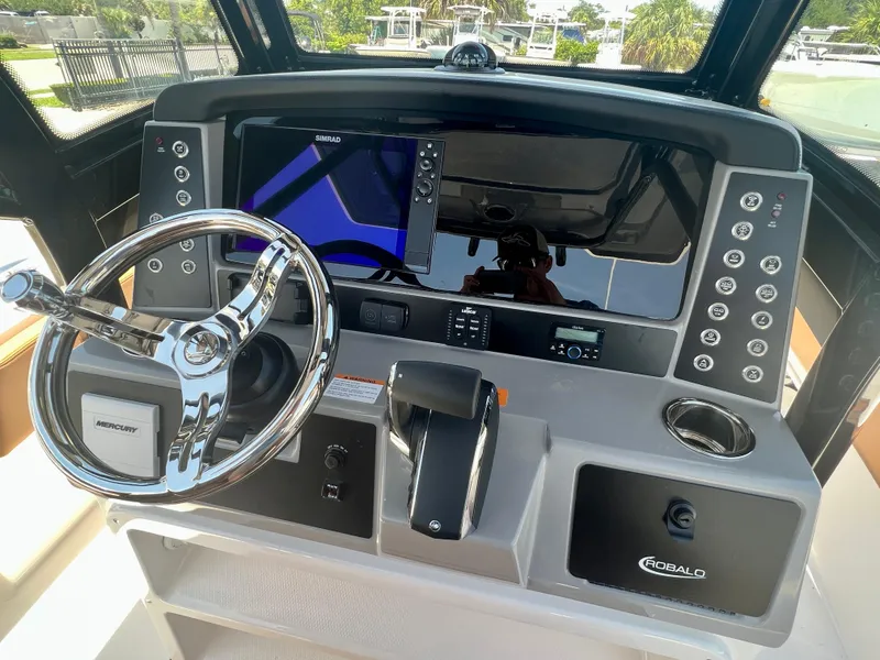 Slide: The Image of Robalo 266 Cayman 2025 helm with Simrad display and Mercury controls. - 17