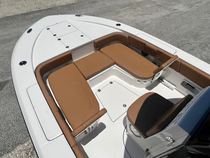 Slide: The Image of 2025 Robalo 266 Cayman with brown seating and white deck. - 27