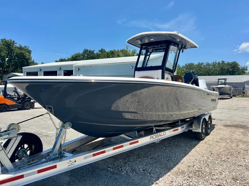 Slide: The Image of 2025 Robalo 266 Cayman boat on trailer outdoors. - 3