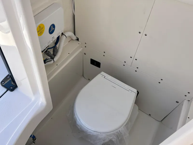 Slide: The Image of Interior of 2025 Robalo 266 Cayman featuring a toilet. - 30