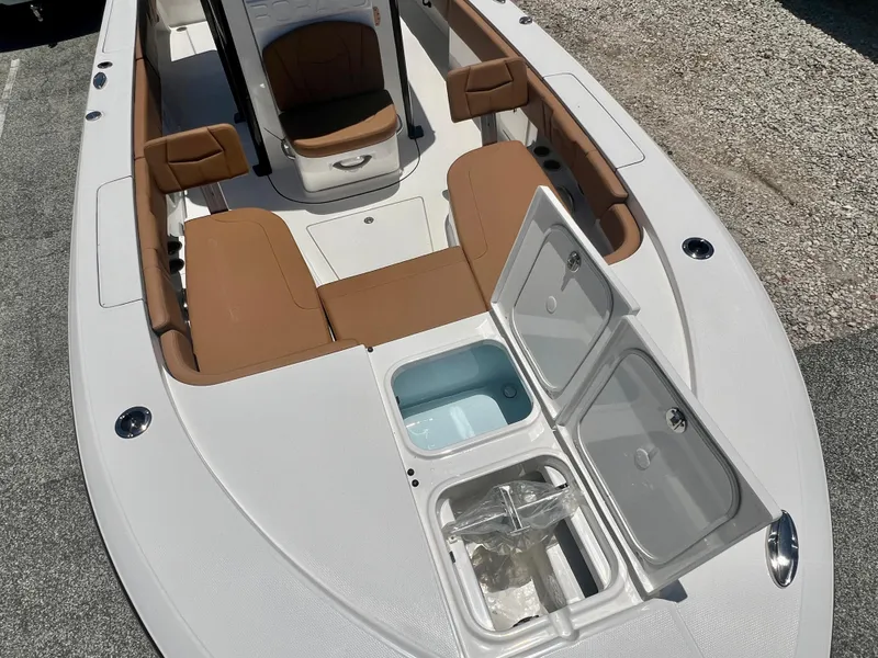Slide: The Image of 2025 Robalo 266 Cayman with open storage hatch and seating area. - 34