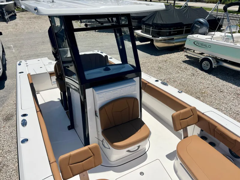Slide: The Image of 2025 Robalo 266 Cayman boat with brown seats and white deck. - 35