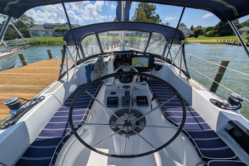 Slide: The Image of Cockpit view of 1999 Beneteau Oceanis 361 sailboat with steering wheel and navigation equipment. - 12
