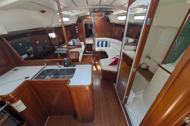 Slide: The Image of Interior of 1999 Beneteau Oceanis 361 sailboat with wood finish and cozy seating area. - 15