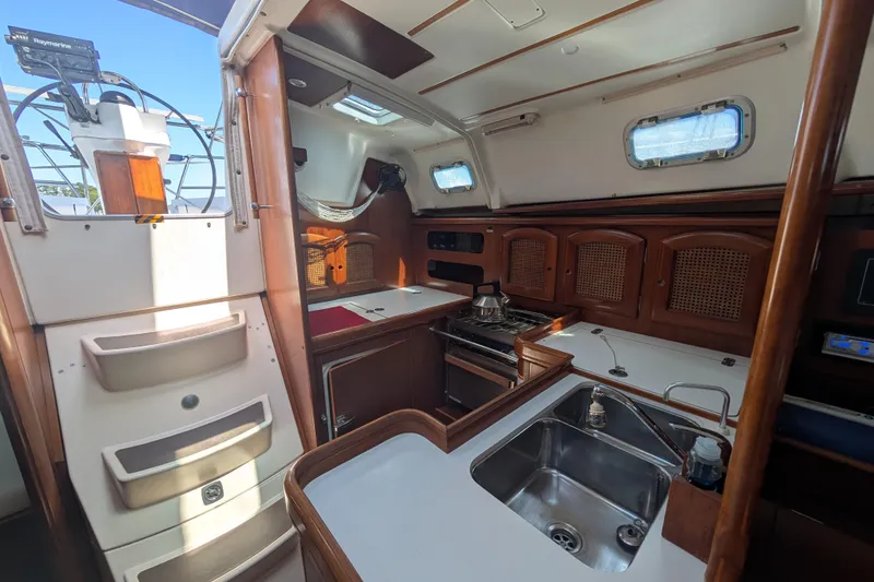 Slide: The Image of Interior of 1999 Beneteau Oceanis 361 sailboat with kitchen and wooden cabinetry. - 17