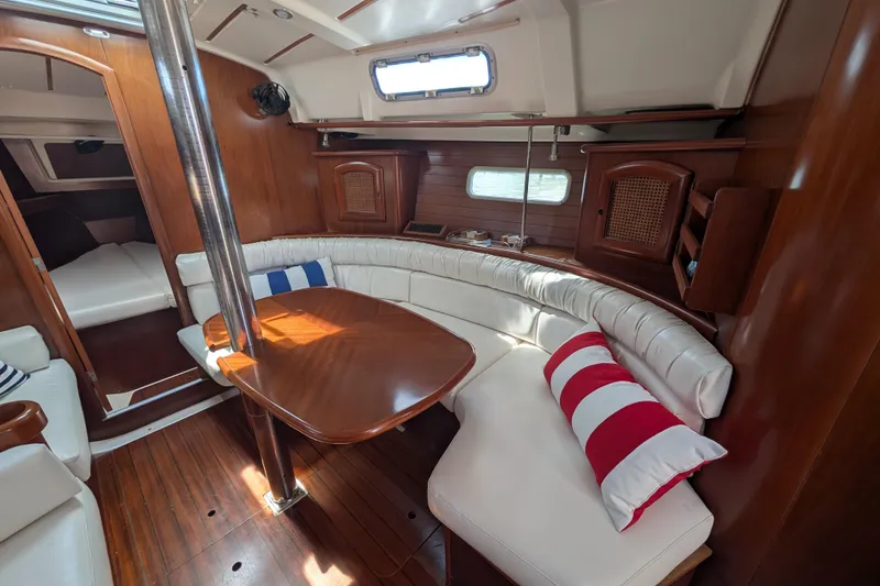 Slide: The Image of Interior of 1999 Beneteau Oceanis 361 sailboat with wooden finish and white seating. - 21