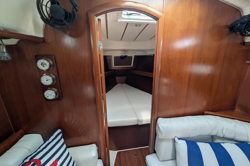 Slide: The Image of Interior of 1999 Beneteau Oceanis 361 sailboat, featuring cozy cabin and nautical decor. - 22
