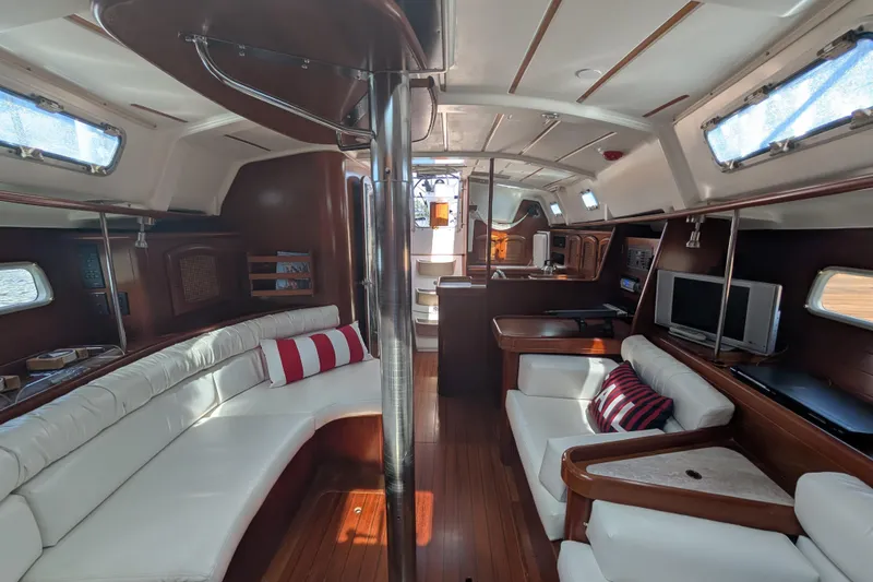 Slide: The Image of Interior of 1999 Beneteau Oceanis 361 yacht with elegant wood and white seating. - 24