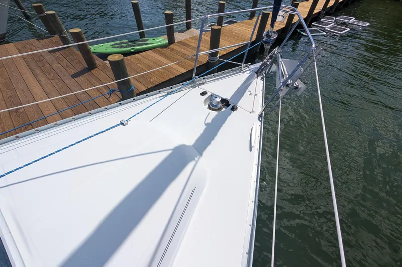 Slide: The Image of Bow of 1999 Beneteau Oceanis 361 sailboat docked by wooden pier. - 7