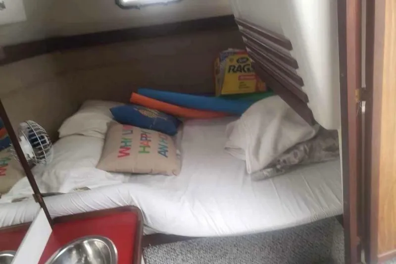 Slide: The Image of Cozy cabin interior of 1985 Carver 28 Riviera with bed, pillows, and fan. - 14