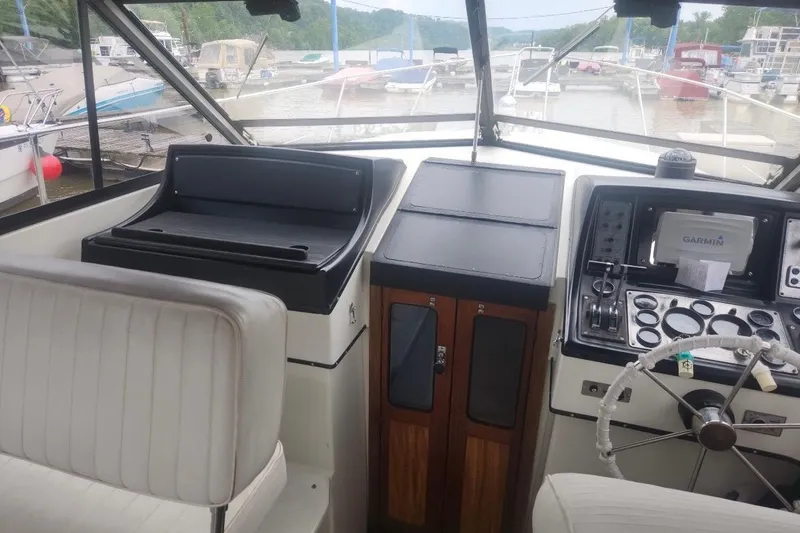 Slide: The Image of Interior view of 1985 Carver 28 Riviera boat cockpit with steering wheel and navigation equipment. - 9