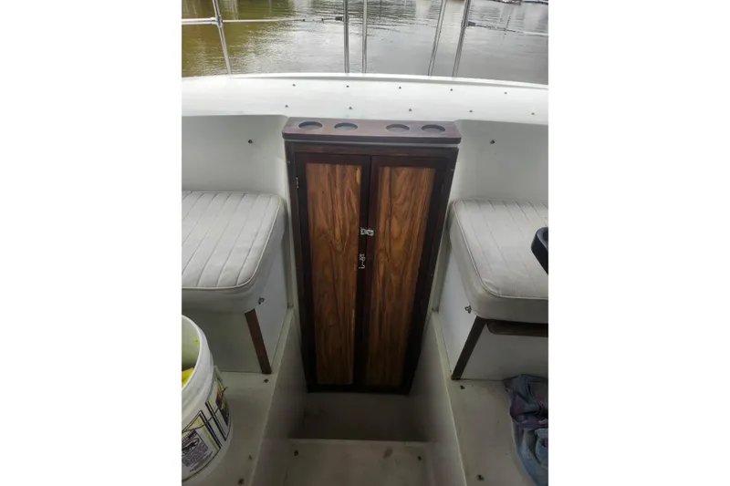 Slide: The Image of 1985 Carver 28 Riviera interior with wooden cabinet and cushioned seating. - 10