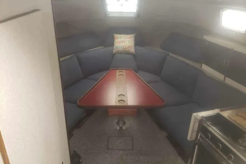 Slide: The Image of Interior of 1985 Carver 28 Riviera boat with cozy seating and table. - 12