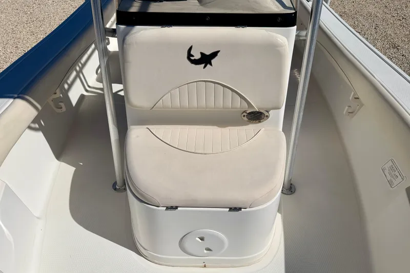 Slide: The Image of 2014 Mako 184 Center Console boat interior with cushioned seating and shark logo. - 11