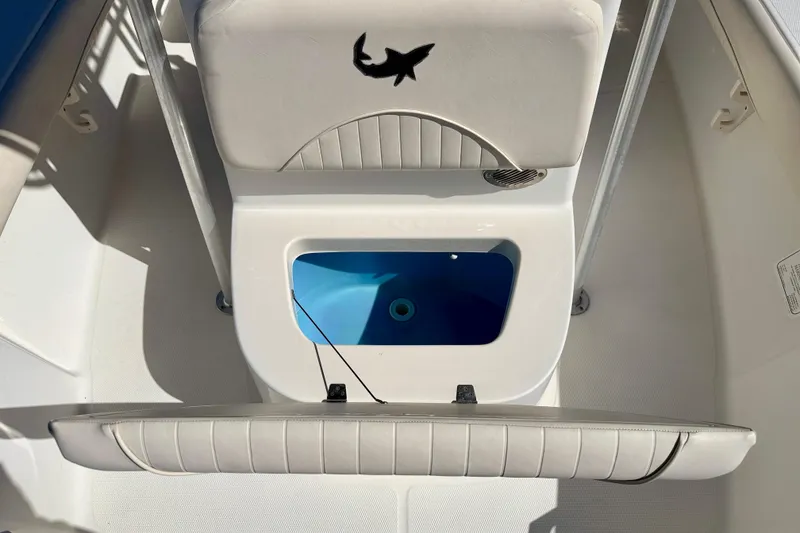 Slide: The Image of 2014 Mako 184 Center Console boat interior with open storage compartment. - 12