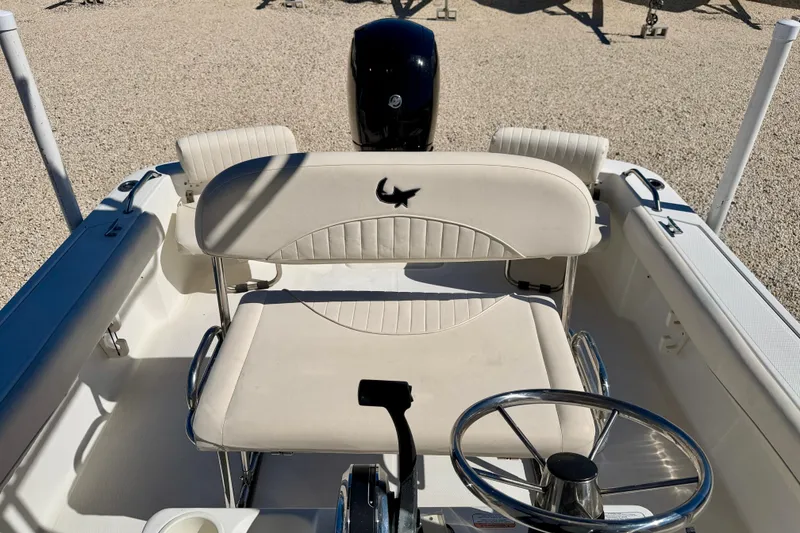 Slide: The Image of 2014 Mako 184 Center Console boat interior with steering wheel and seating. - 13