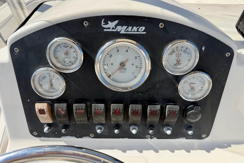 Slide: The Image of Dashboard of a 2014 Mako 184 Center Console boat with gauges and switches. - 17