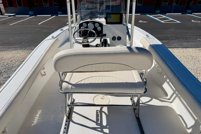 Slide: The Image of 2014 Mako 184 Center Console boat interior with steering wheel and seating. - 18